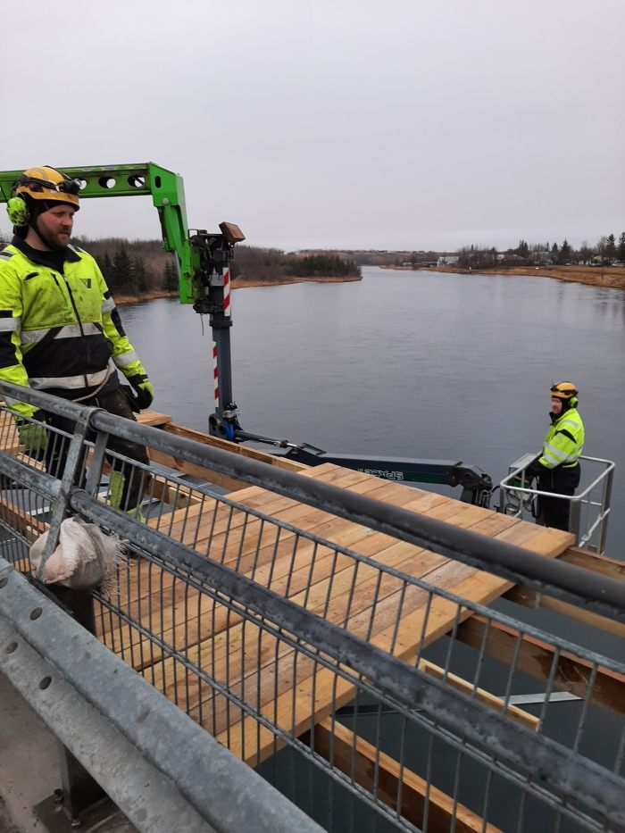 Unnið við að setja upp gólf göngubrúarinnar.
